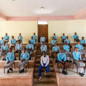 Class 8 Blockbusters 2020, pose for a class photo with their class teacher, Mr Michael Kivai.