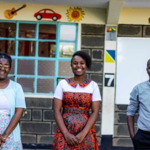 Members of the finance department look jovial, as they pose for a photo. From the left is Madam Jane, Madam Emmah, and Mr Moses.